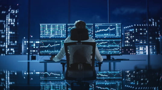 Utilizing StoneX Pro platforms, a financial analyst reviews market data across screens, managing 100+ liquidity relationships